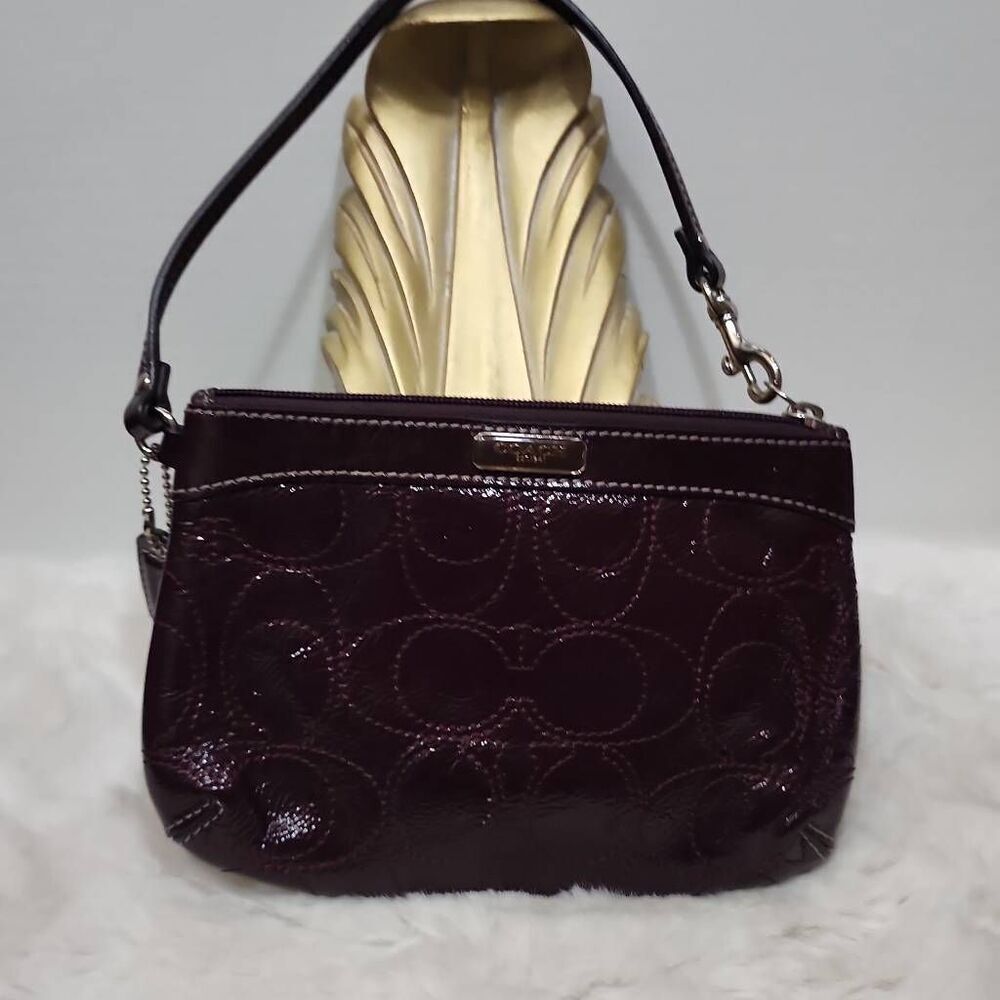 Coach Burgundy Patent Leather Logo Embossed Wristlet Clutch Bag.
